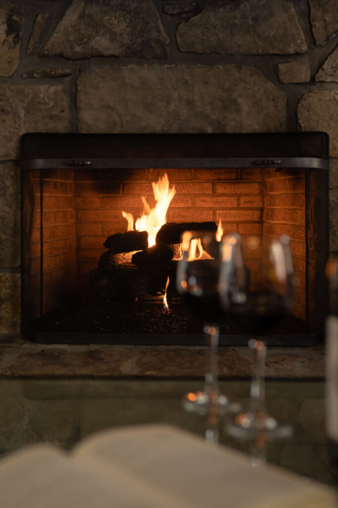 Cozy fireplace and wineglasses