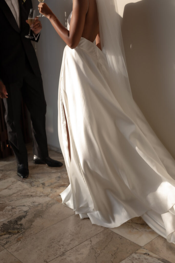 Bride and groom sharing champagne during a luxury Tuscany wedding celebration