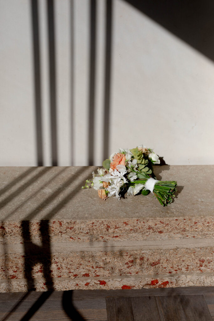 Bridal bouquet resting in soft shadow during a luxury Tuscany wedding